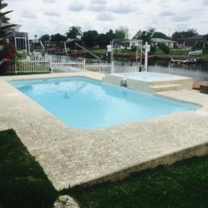 Tropical 13' x 25' Pettit Fiberglass Pool with deck and overflow spa